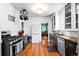 Well-lit kitchen featuring hardwood floors, stainless steel appliances, and hanging pot rack at 4321 Winona Ct, Denver, CO 80212