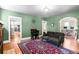 Spacious living room with hardwood floors, a comfortable sofa, and open doorways at 4321 Winona Ct, Denver, CO 80212