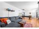 Cozy living room with sectional sofa, hardwood floors, and a view of the pool table room at 4321 Winona Ct, Denver, CO 80212