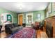 Bright living room with fireplace, wood floors, comfortable sofa, and natural light at 4321 Winona Ct, Denver, CO 80212
