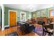 Inviting living room featuring hardwood floors, a brick fireplace, and large windows at 4321 Winona Ct, Denver, CO 80212