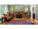 Cozy living room featuring fireplace, wood floors, and bookshelves; ideal for relaxation at 4321 Winona Ct, Denver, CO 80212
