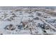 Aerial view of a residential neighborhood with houses and snowy landscape at 16122 Emporia Way, Brighton, CO 80602