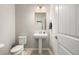 Small powder room with pedestal sink and toilet at 16122 Emporia Way, Brighton, CO 80602