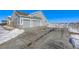 Two-car garage with gray doors and ample driveway space at 16122 Emporia Way, Brighton, CO 80602