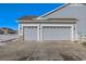 Two-car attached garage with gray doors, spacious driveway at 16122 Emporia Way, Brighton, CO 80602