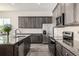 Modern kitchen with granite countertops, stainless steel appliances, and ample cabinetry at 16122 Emporia Way, Brighton, CO 80602