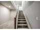 Carpeted staircase leading to the upper level at 16122 Emporia Way, Brighton, CO 80602