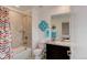 Well-lit bathroom with a shower-tub combo, single vanity, and sleek modern fixtures at 2454 Ambience Ln, Castle Rock, CO 80109