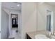 Bright bathroom featuring single sink vanity with a view into an adjacent bedroom at 2454 Ambience Ln, Castle Rock, CO 80109