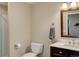 Neutral-toned bathroom featuring a dark vanity, a framed mirror, and a tiled shower space at 2454 Ambience Ln, Castle Rock, CO 80109