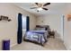 Cozy bedroom featuring neutral walls, a comfortable bed, and blue curtains for natural light at 2454 Ambience Ln, Castle Rock, CO 80109