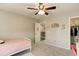 Comfortable bedroom with a ceiling fan and view to the staircase landing and upstairs hallway at 2454 Ambience Ln, Castle Rock, CO 80109