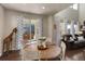 Bright dining room with a round wooden table, large windows and sliding glass door at 2454 Ambience Ln, Castle Rock, CO 80109