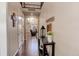 Welcoming entryway with hardwood floors and decorative console table with flowers and a lantern at 2454 Ambience Ln, Castle Rock, CO 80109