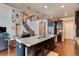 Modern kitchen island with granite countertops, stainless steel appliances, and dark cabinets at 2454 Ambience Ln, Castle Rock, CO 80109