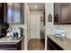 Kitchen with dark cabinets, granite countertops, stainless steel appliances, and hardwood flooring at 2454 Ambience Ln, Castle Rock, CO 80109