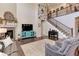 Bright living room featuring a fireplace, staircase, and hardwood floors at 2454 Ambience Ln, Castle Rock, CO 80109