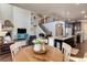 Open-concept living space featuring a fireplace, kitchen, dining table and staircase at 2454 Ambience Ln, Castle Rock, CO 80109