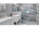 Modern bathroom featuring a glass enclosed shower, double vanity, and mosaic tile accent wall at 4013 S Carson St # C, Aurora, CO 80014