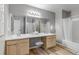 Bright bathroom featuring double sinks, a large mirror, and a shower-tub combination at 4013 S Carson St # C, Aurora, CO 80014