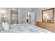 Primary bedroom featuring an ensuite bathroom, dresser, and soft white color palette at 4013 S Carson St # C, Aurora, CO 80014