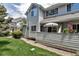 Exterior view of a house with a patio, lawn and neatly landscaped bushes at 4013 S Carson St # C, Aurora, CO 80014