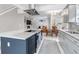 Bright kitchen with large island and stainless-steel appliances, with views into the dining and living areas at 4013 S Carson St # C, Aurora, CO 80014