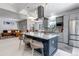 Open concept kitchen with large island, granite countertops, stainless appliances and adjacent living and dining areas at 4013 S Carson St # C, Aurora, CO 80014