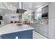 Open concept kitchen featuring a large island, granite countertops, and stainless-steel appliances with a view to living area at 4013 S Carson St # C, Aurora, CO 80014