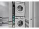 Convenient laundry area with stacked washer and dryer, complemented by stylish tile backsplash at 4013 S Carson St # C, Aurora, CO 80014