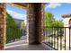 A spacious balcony features stone supports and wrought iron railing overlooking the neighborhood at 3454 Cascina Pl # D, Highlands Ranch, CO 80126