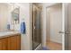 Bathroom featuring a shower, sink, vanity and neutral tile providing a clean and functional space at 3454 Cascina Pl # D, Highlands Ranch, CO 80126