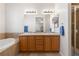 Bathroom with double sinks, lots of lights, and an adjoining room with a separate tub and shower at 3454 Cascina Pl # D, Highlands Ranch, CO 80126