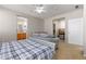 Bright bedroom features a ceiling fan, natural light, and an adjoining bathroom, creating comfort at 3454 Cascina Pl # D, Highlands Ranch, CO 80126