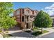 Beautiful two-story home with stone accents, a balcony, a three car garage, and mature trees at 3454 Cascina Pl # D, Highlands Ranch, CO 80126