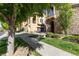 Charming exterior showcases stone accents, a private balcony, lush lawn, and a welcoming entryway at 3454 Cascina Pl # D, Highlands Ranch, CO 80126