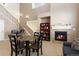 Living room with a fireplace, staircase, and an adjacent dining area at 3454 Cascina Pl # D, Highlands Ranch, CO 80126