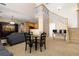 Open floor plan living room with staircase, high ceiling, and adjacent kitchen at 3454 Cascina Pl # D, Highlands Ranch, CO 80126