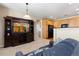 Inviting living room that flows into the kitchen featuring light colored walls and carpet at 3454 Cascina Pl # D, Highlands Ranch, CO 80126