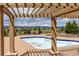 A refreshing pool under a pergola with mountain views offers a relaxing outdoor experience at 3454 Cascina Pl # D, Highlands Ranch, CO 80126