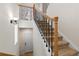 Carpeted staircase with decorative metal and wood banister leads to the upper level at 3454 Cascina Pl # D, Highlands Ranch, CO 80126