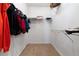 A functional walk-in closet with shelving provides lots of storage and organization for clothing and personal items at 3454 Cascina Pl # D, Highlands Ranch, CO 80126