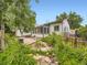 Lush backyard featuring mature landscaping, patio area, and sunroom off the main house at 2260 Leyden St, Denver, CO 80207