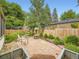 Charming backyard patio with stone pavers, fire pit, mature trees, and attractive landscaping at 2260 Leyden St, Denver, CO 80207