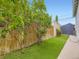 Backyard featuring artificial turf, a wood fence, and mature landscaping at 2260 Leyden St, Denver, CO 80207