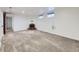 Spacious carpeted basement area with a decorative brick fireplace and two windows for natural light at 2260 Leyden St, Denver, CO 80207