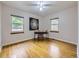 Bright bedroom featuring hardwood floors, two windows, and a stylish desk setup at 2260 Leyden St, Denver, CO 80207