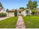 Charming single-story home with a well-manicured lawn and inviting stone walkway at 2260 Leyden St, Denver, CO 80207
