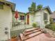 Charming porch featuring stone steps, seating area, and a red striped umbrella for relaxing outdoors at 2260 Leyden St, Denver, CO 80207